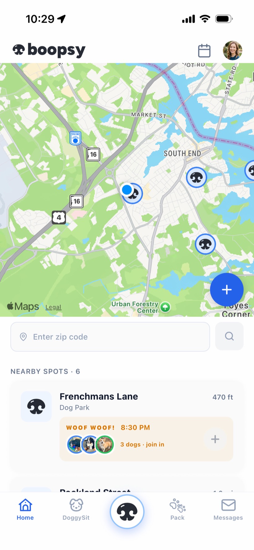 The Boopsy app showing nearby dog parks on a live map, with a busy park and dogs heading there now